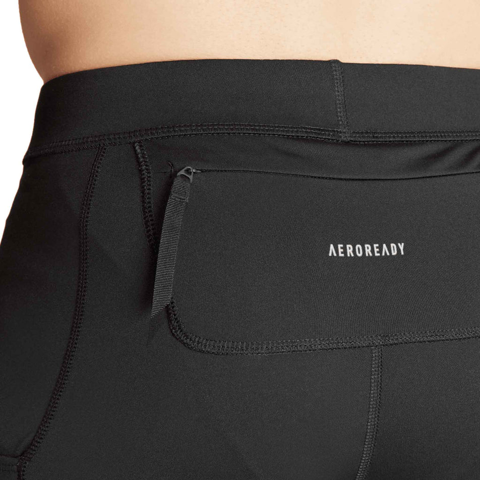 Close-up view of the zip pocket on the back of the adidas Men's Own The Run Short Tights in the Black colourway. (8751020671138)