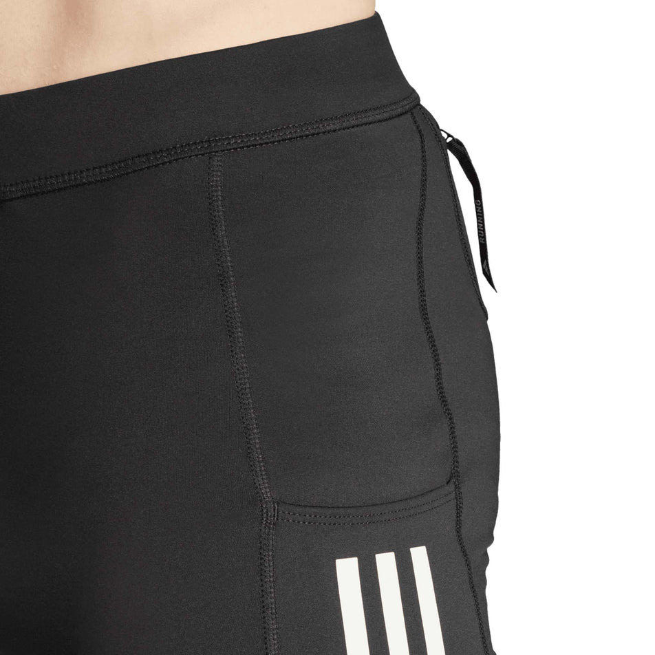 Close-up view of the side pocket on the side of the adidas Men's Own The Run Short Tights in the Black colourway. (8751020671138)