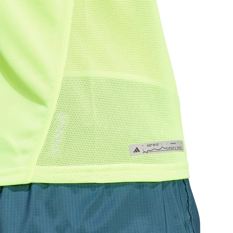 Lower side of an adidas Women's Ultimate Knit T-Shirt in the Lucid Lemon colourway. adidas branding is visible.  (8005345771682)