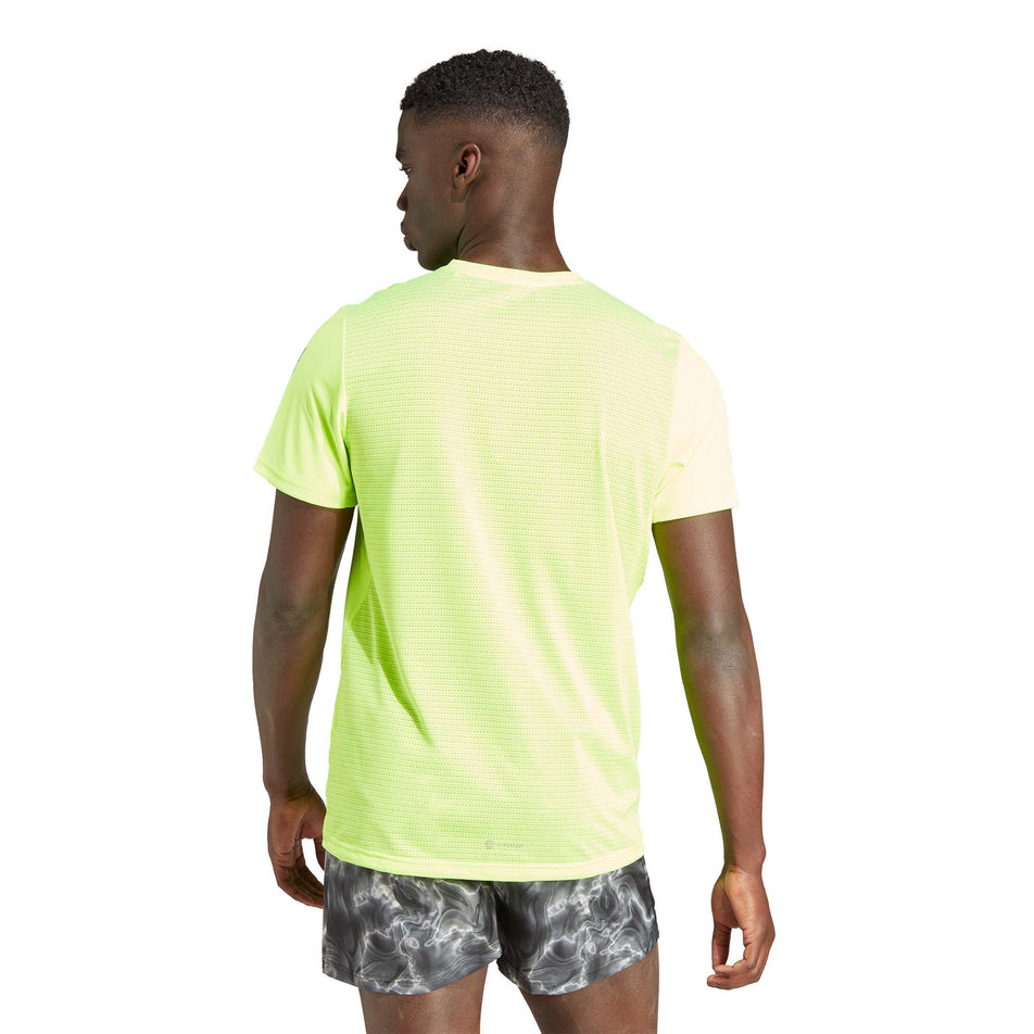 Back view of a model wearing an adidas Men's Own the Run Tee in the Lucid Lemon colourway (8005317394594)