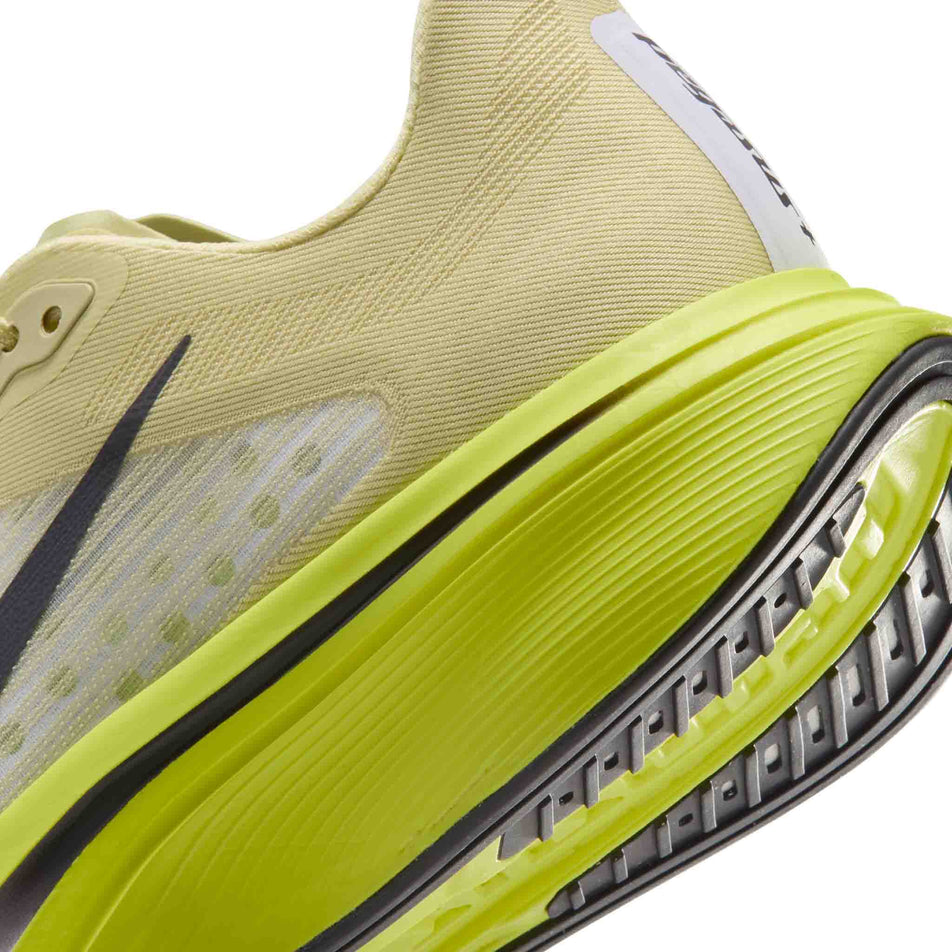 Close-up view of the rearfoot sectionof the left shoe from a pair of Nike Women's Pegasus Plus 2 Road Running Shoes in the Fennel/Gridiron-Lemon Venom colourway.