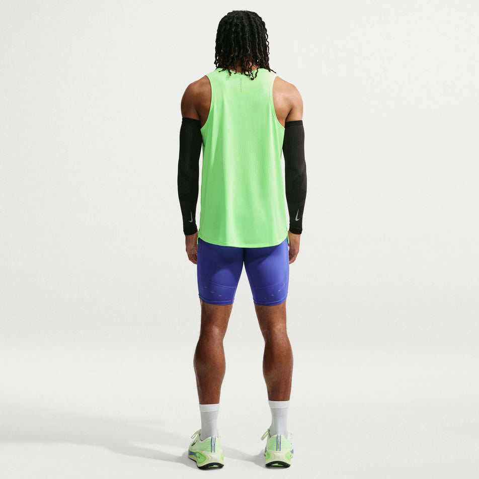Back view of a model wearing the Nike Men's Stride Aero-FIT Running Tank Top in the Volt/Light Silver/Reflective Silver colourway.