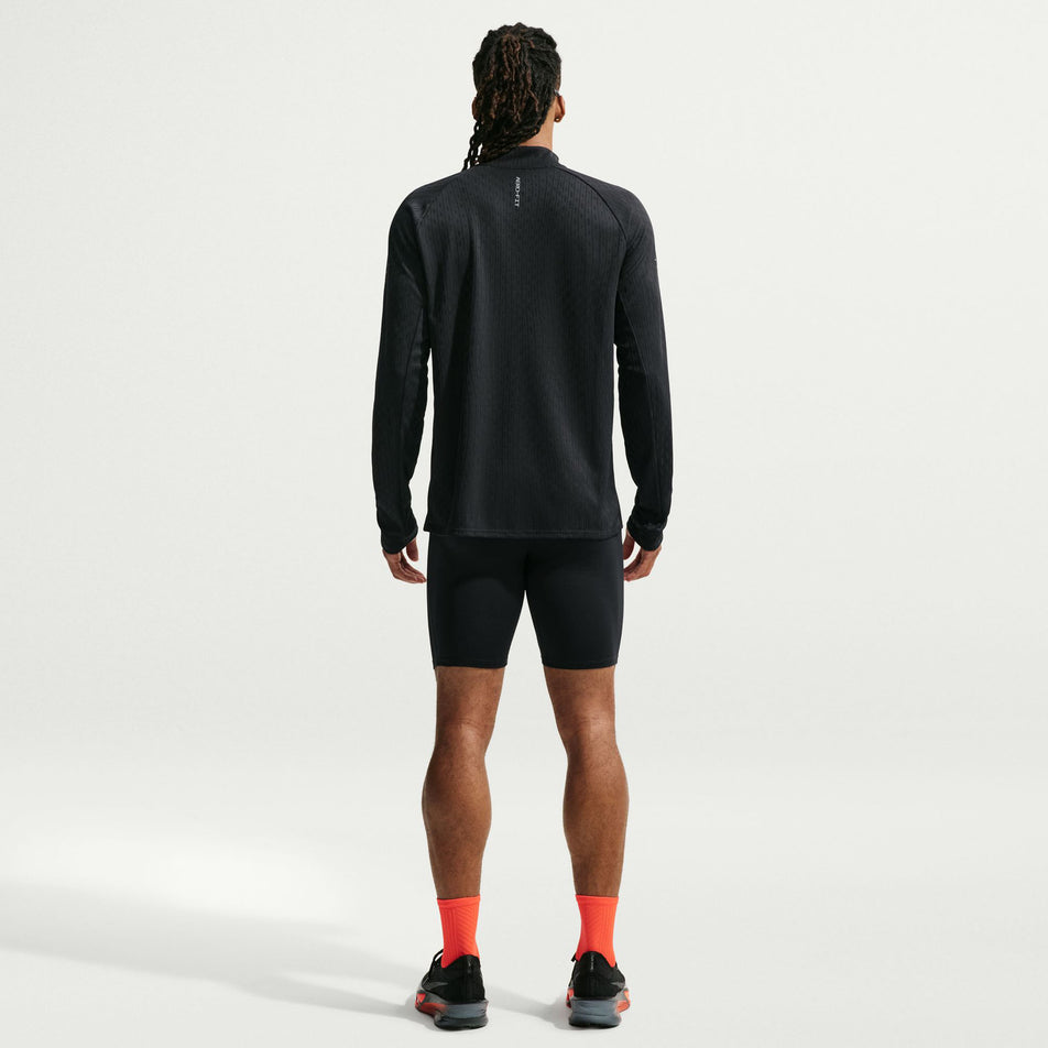 Back view of a model wearing the Nike Men's Stride Aero-FIT 1/2-Zip Mid Layer in the Black/Reflective Silver colourway.