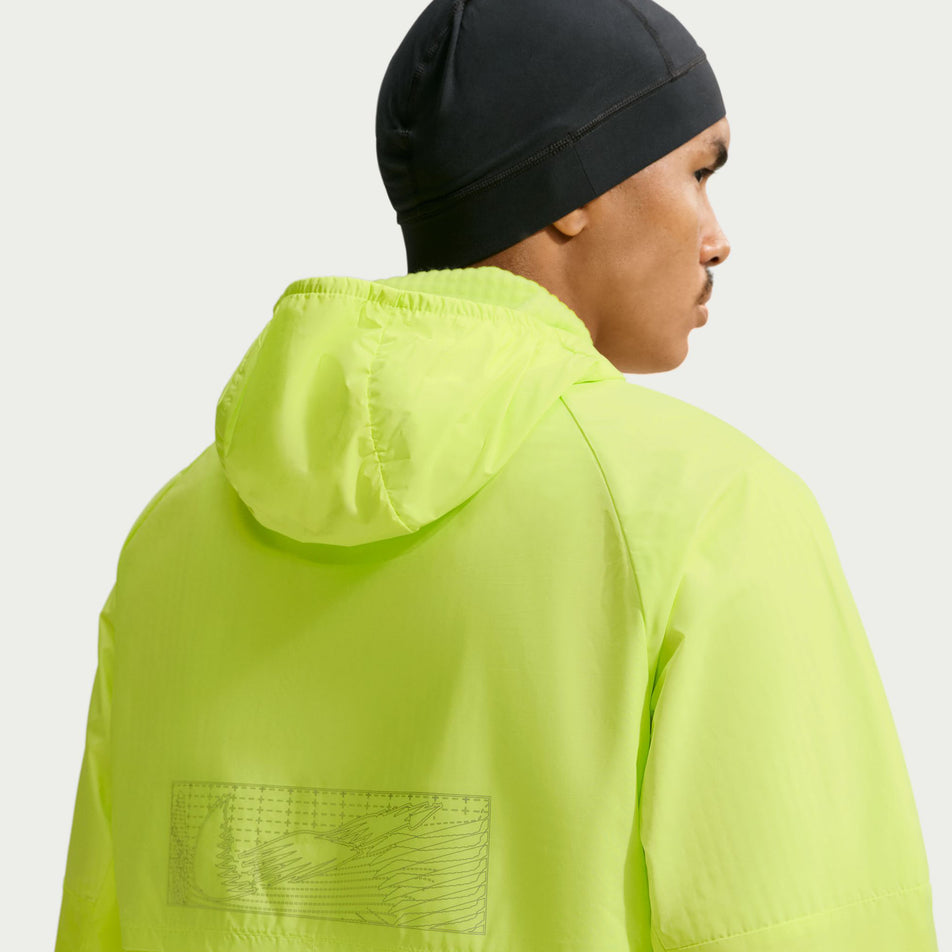 Back view of a model wearing the Nike Men's Miler Therma-FIT Repel Winterized Running Jacket in the Light Lemon Twist colourway.