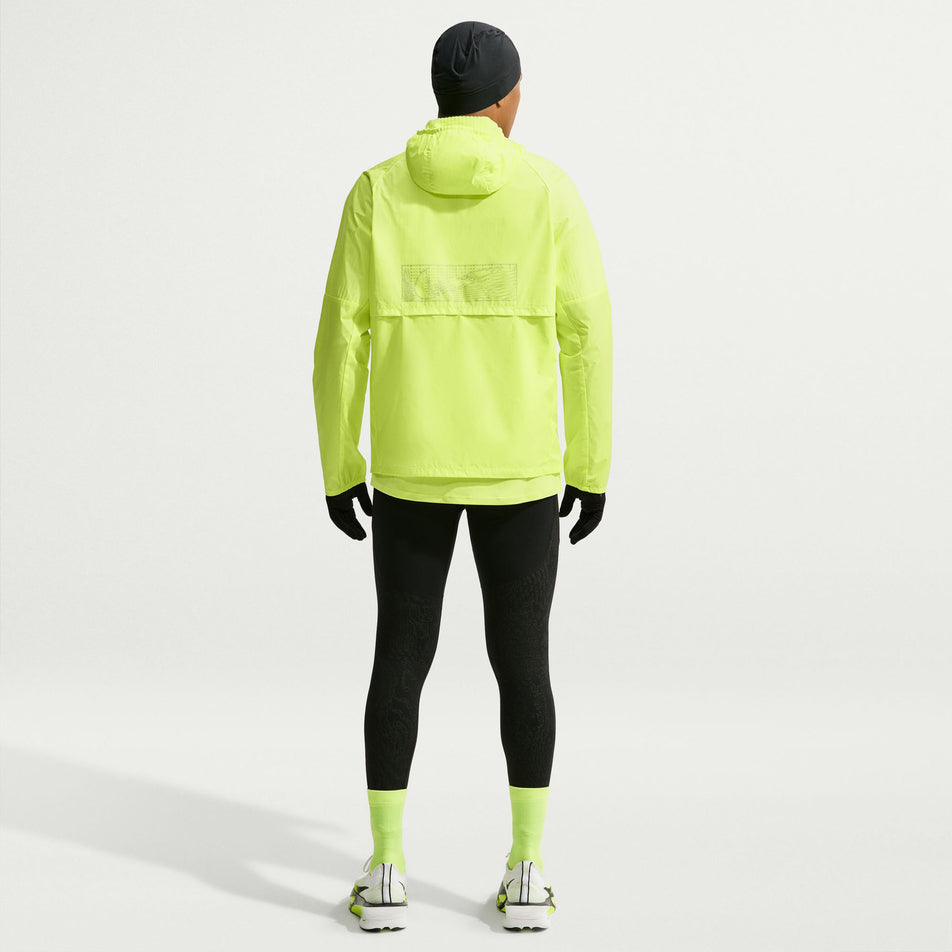 Back view of a model wearing the Nike Men's Miler Therma-FIT Repel Winterized Running Jacket in the Light Lemon Twist colourway.