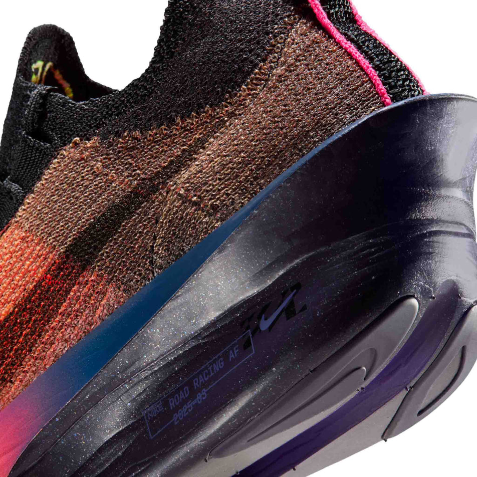 Close-up view of the rearfoot section of the left shoe from a pair of Nike Women's Alphafly 3 Road Racing Shoes in the Orange Pulse/Black-Purple Dynasty colourway.