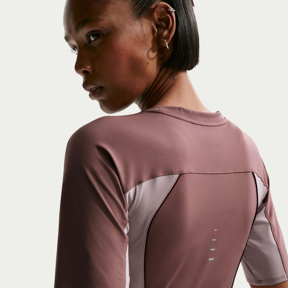 Back view of the Nike Women's Swift Dri-FIT Short-Sleeve Running Top in the Tattoo/Light Violet Ore/Reflective Silver colourway.