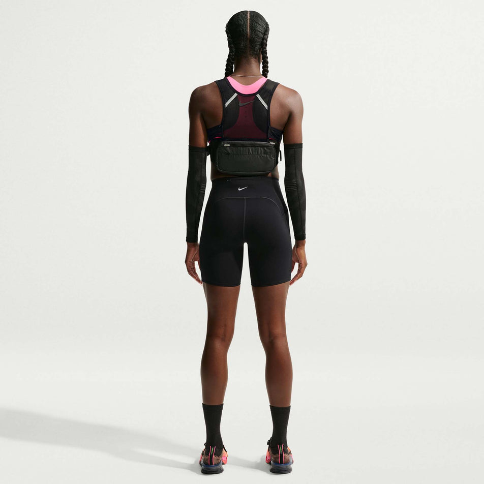 Back view of a model wearing the Nike Women's Swift Dri-FIT High-Waisted 7