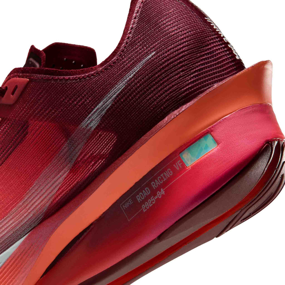 Close-up view of the rearfoot section of the left shoe from a pair of Nike Women's Vaporfly 4 SE Road Racing Shoes in the Team Red/Barely Green-Atomic Pink colourway.