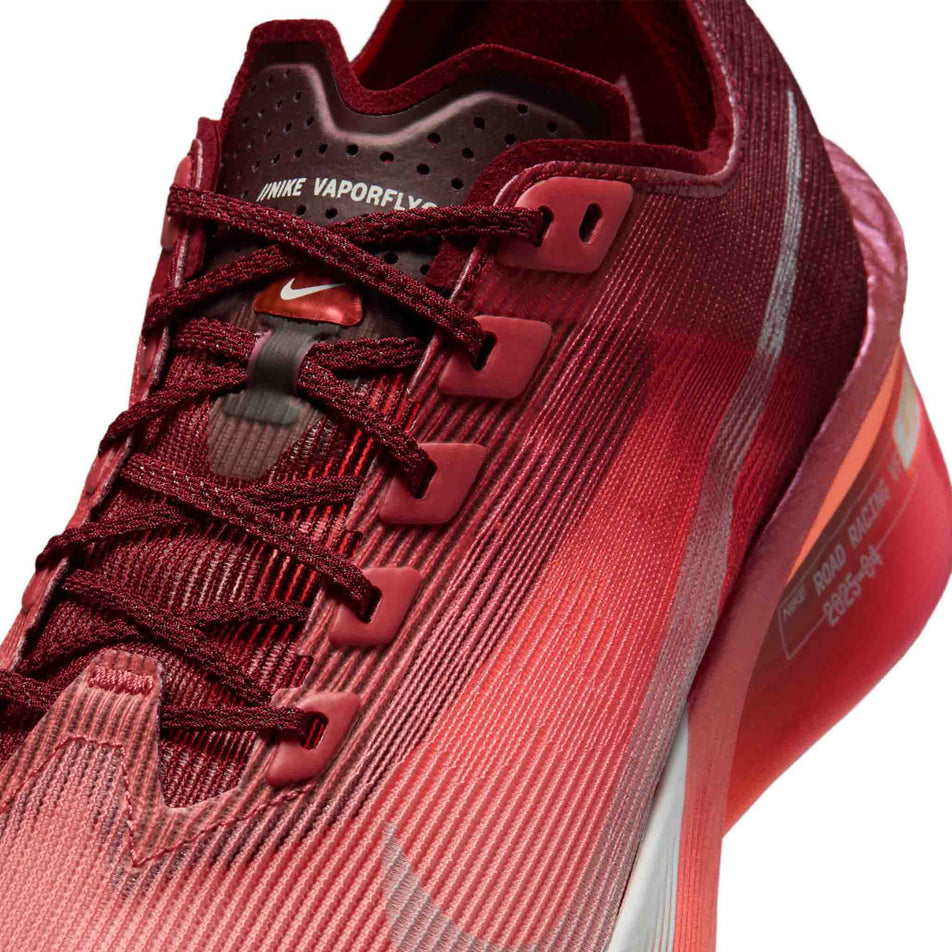 Close-up view of the upper of the left shoe from a pair of Nike Women's Vaporfly 4 SE Road Racing Shoes in the Team Red/Barely Green-Atomic Pink colourway.