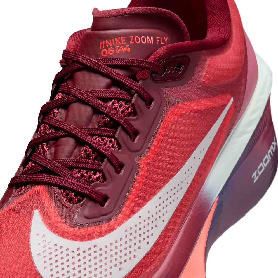 Close-up view of the upper of the left shoe from a pair of Nike Women's Zoom Fly 6 SE Road Running Shoes in the Team Red/Barely Green-Bright Crimson colourway.