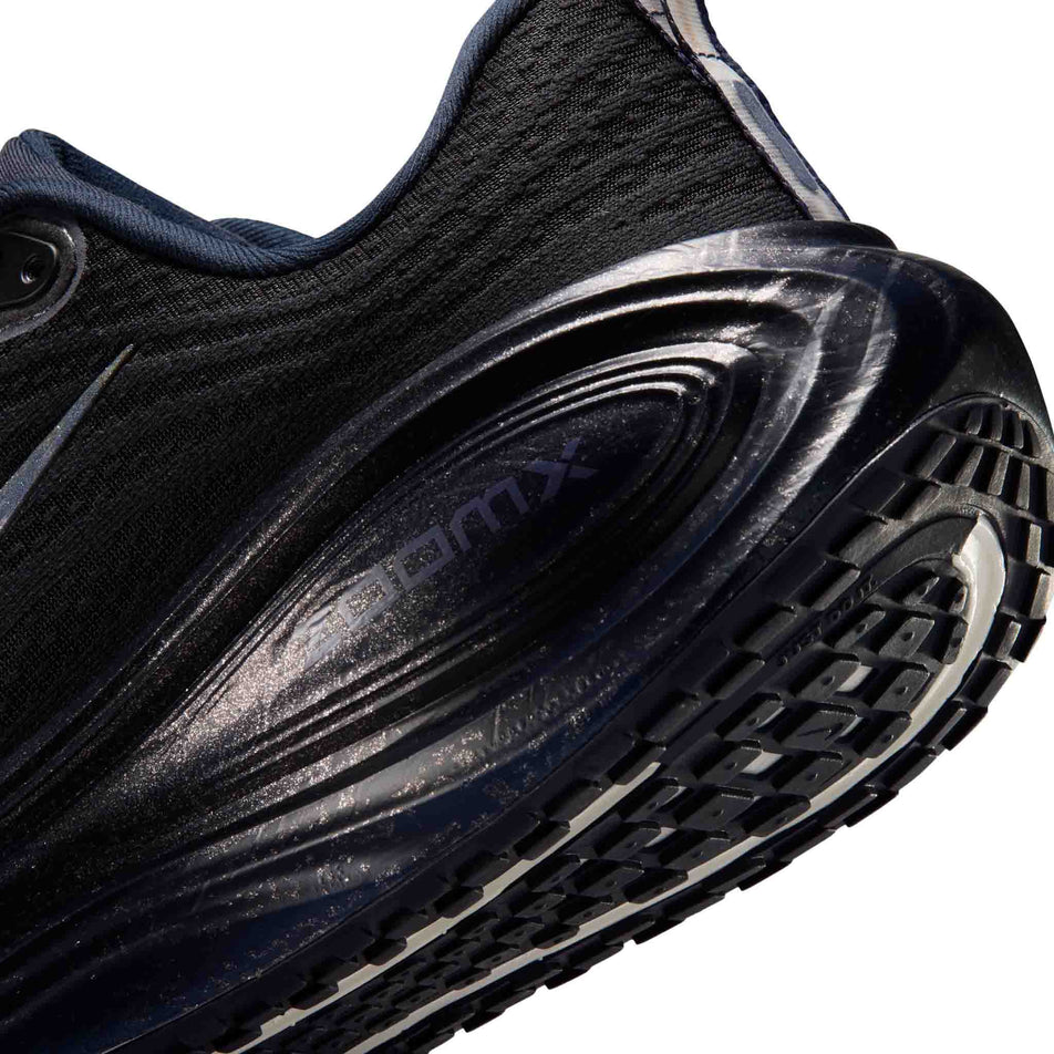 Close-up view of the rearfoot section of the left shoe from a pair of Nike Women's Vomero Plus