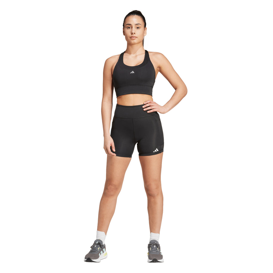 Front view of a model wearing the adidas Women's Own The Run Short Leggings in the Black colourway. (8665248268450)