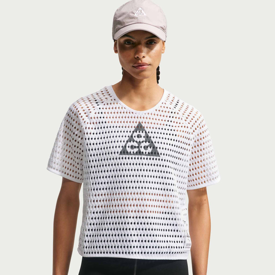 Front view of a model wearing the Nike Women's ACG Radical AirFlow Dri-FIT Short-Sleeve Trail Running Top in the White/Anthracite colourway.