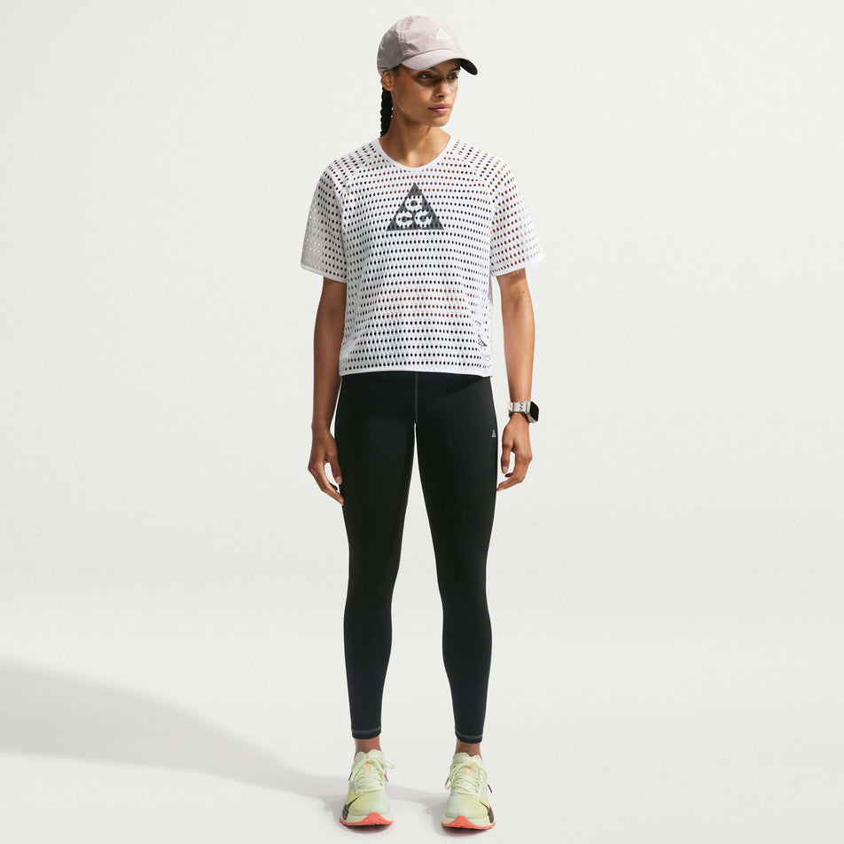 Front view of a model wearing the Nike Women's ACG Radical AirFlow Dri-FIT Short-Sleeve Trail Running Top in the White/Anthracite colourway.