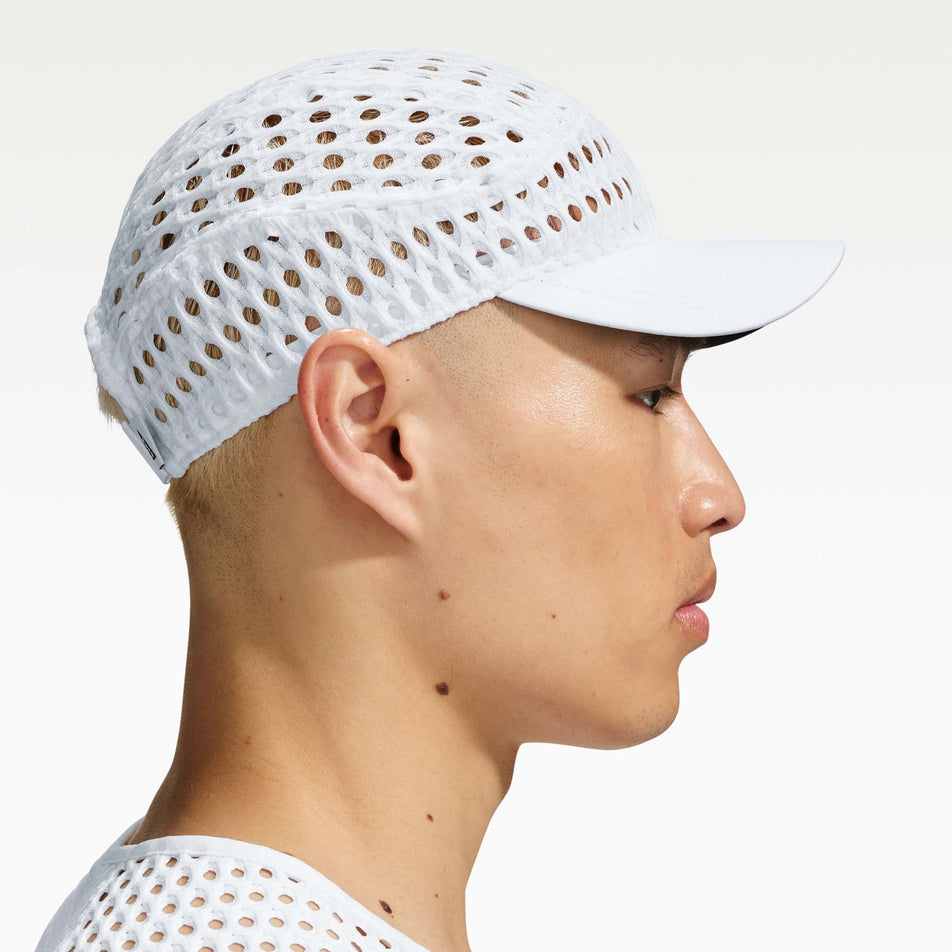 Side view of a model wearing the Nike Unisex ACG Radical AirFlow Fly Cap in the White/White colourway.