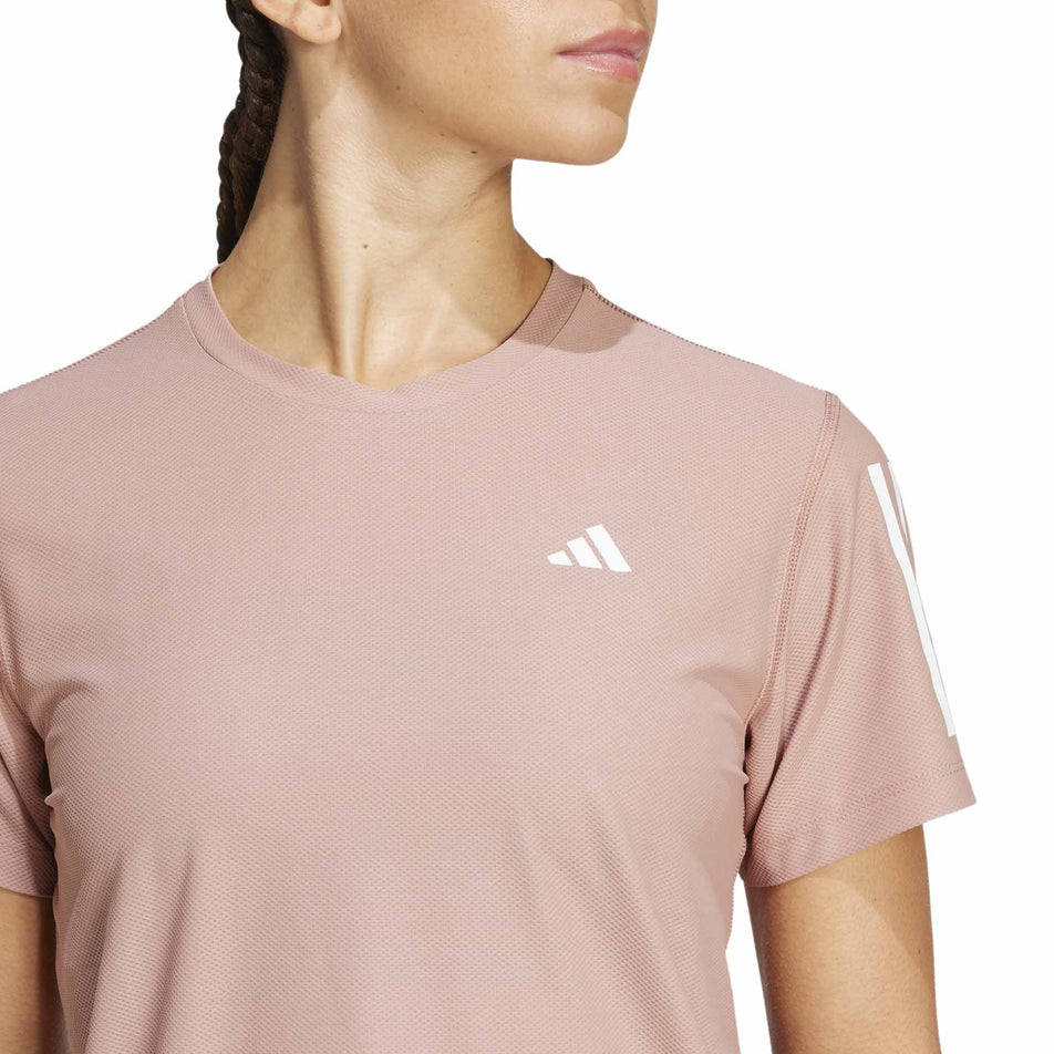 Front view of a model wearing the adidas Women's Own The Run Base Tee in the Warm Clay colourway. (8567456235682)