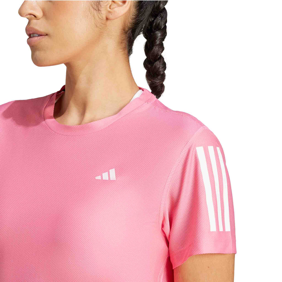 Front view of a model wearing the adidas Women's Own The Run Base Tee in the Pink Fusion colourway. (8567025172642)