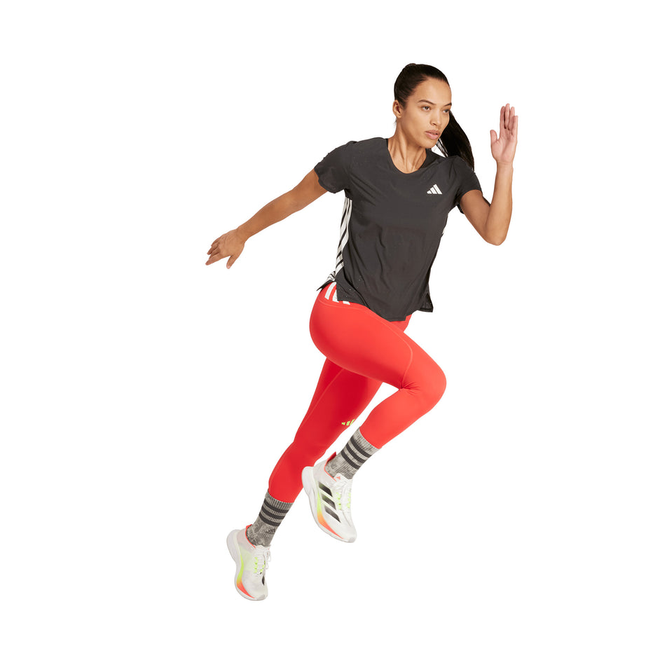Angled view of a model wearing the adidas Women's Adizero Tee in the Black colourway.