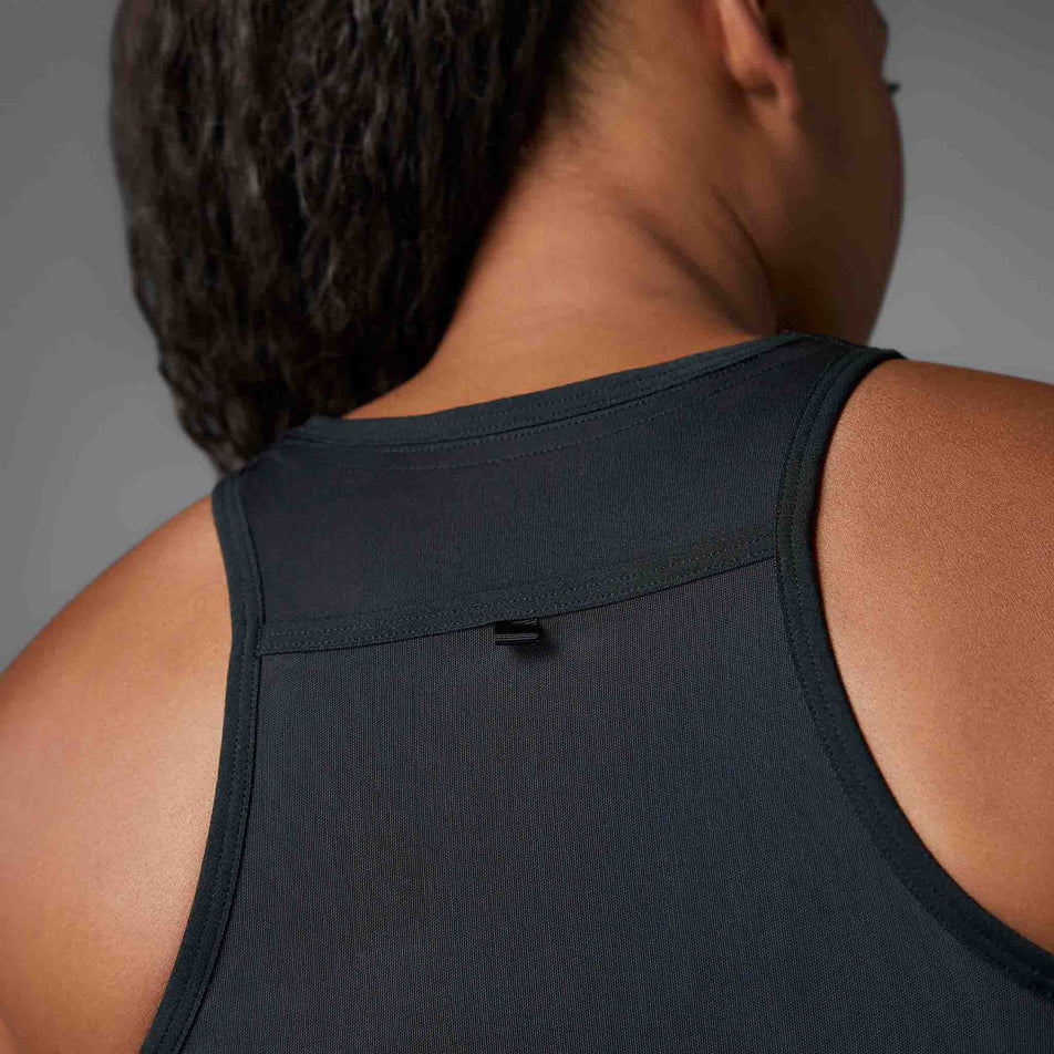 Back view of a model wearing the adidas Women's Adizero Running Gel Pocket Crop in the Black colourway.