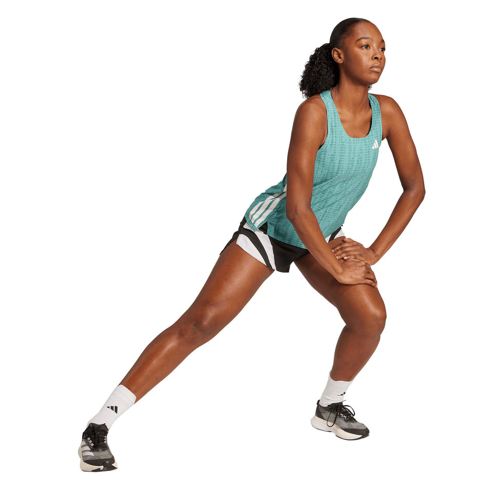 Front view of a model wearing the adidas Women's Adizero Singlet in the Powder Teal/Preloved Teal colourway. (8665224315042)