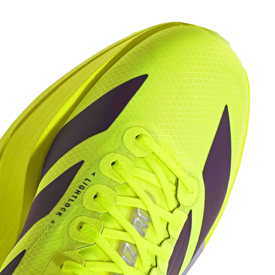 The toe box of the right shoe from a pair of adidas Men's Adizero Adios Pro 4 Running Shoes in the Solar Yellow/Aurora Plum/Powder Plum colourway.