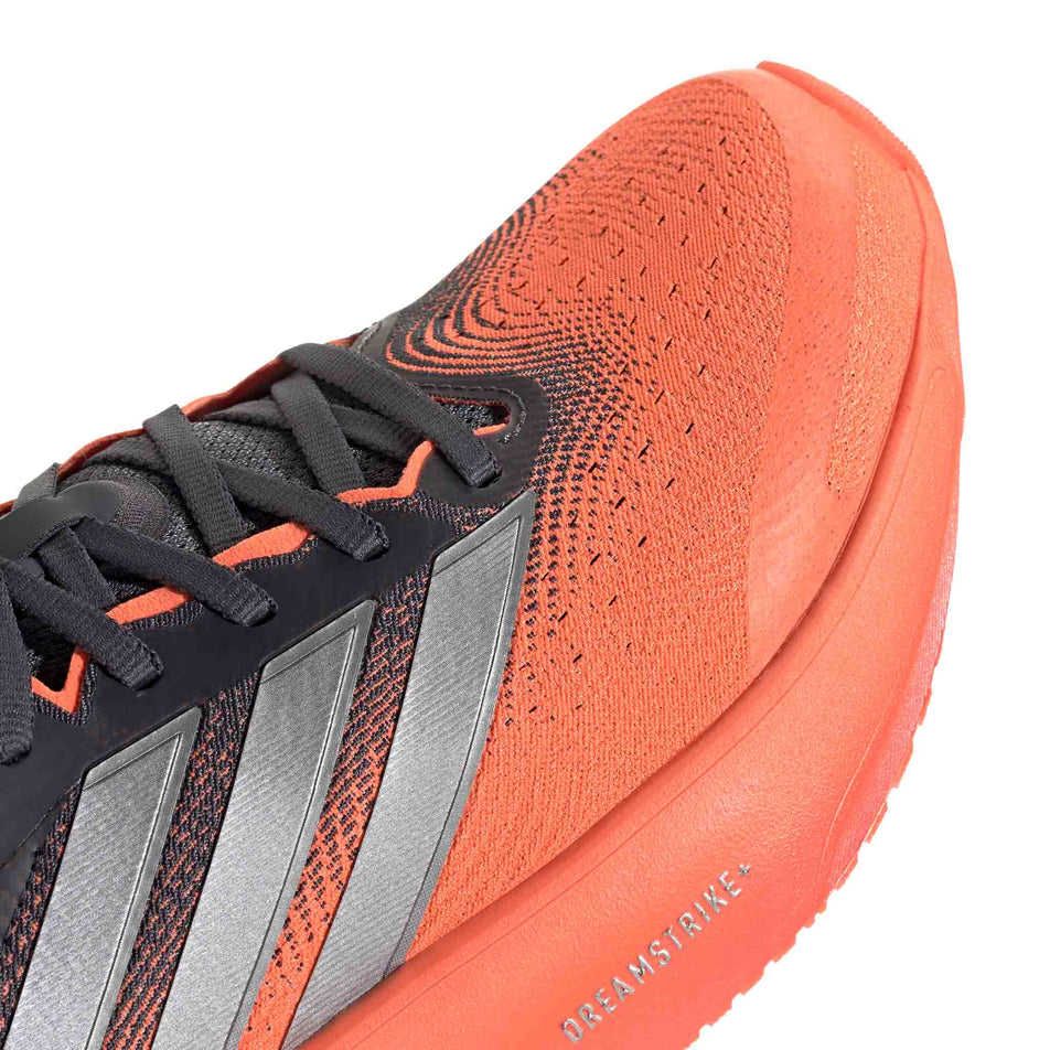 Close-up view of the toebox of the right shoe from a pair of adidas Men's Supernova Rise 3 Running Shoes in the Aurora Onix/Silver met./Lucid Orange colourway.