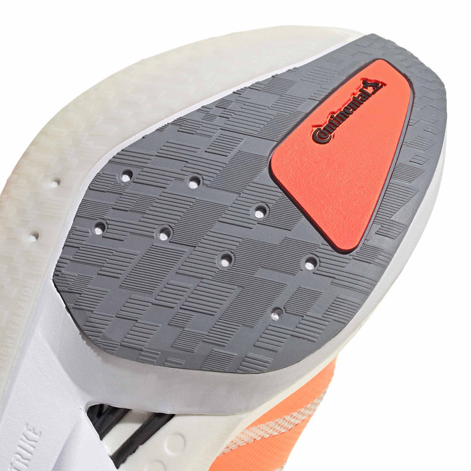 Close-up view of the rubber on the forefoot of the right shoe from a pair of adidas Women's Adizero Boston 13 Running Shoes in the Off White/Beam Orange/Acid Orange colourway.