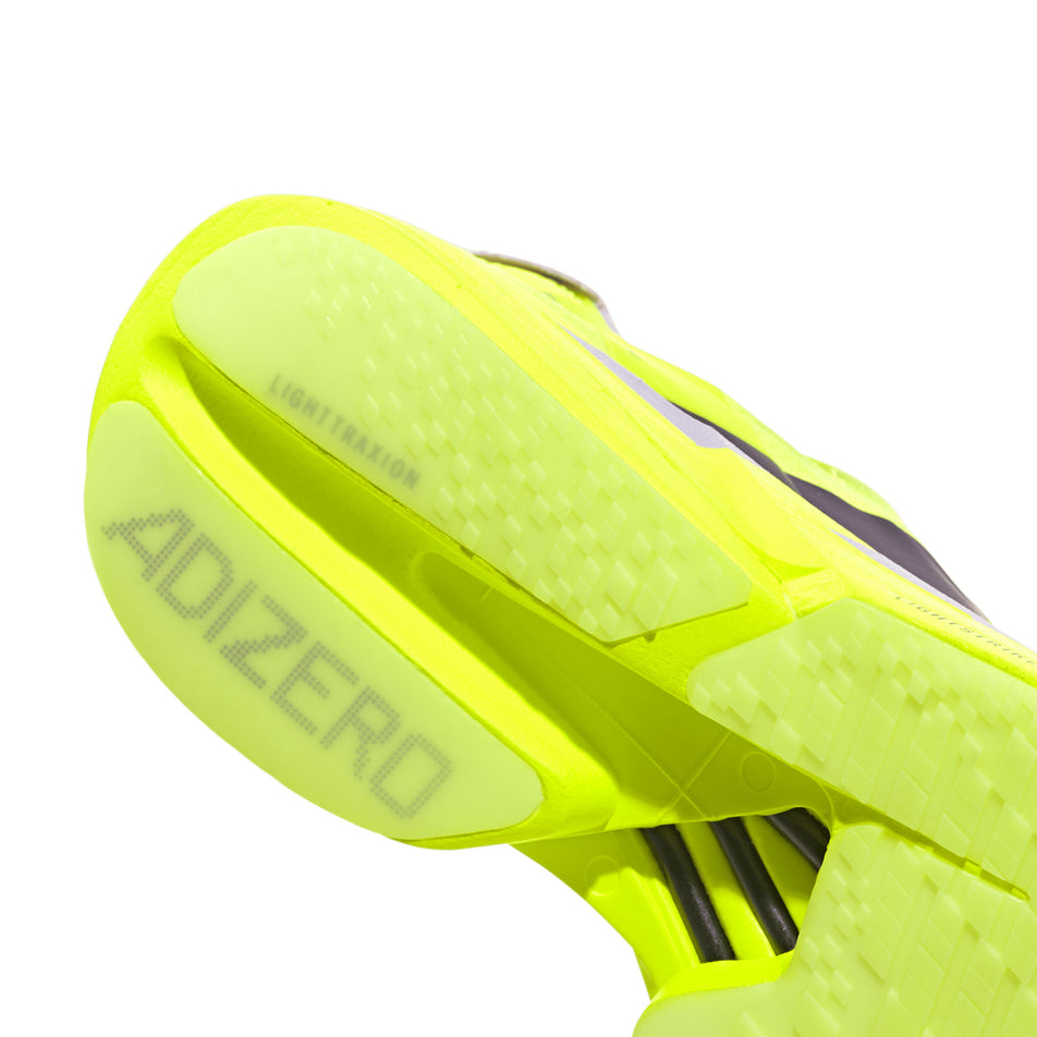 The rearfoot section of the right shoe from a pair of adidas Women's Adizero Adios Pro 4 Running Shoes in the Solar Yellow/Aurora Plum/Powder Plum colourway.
