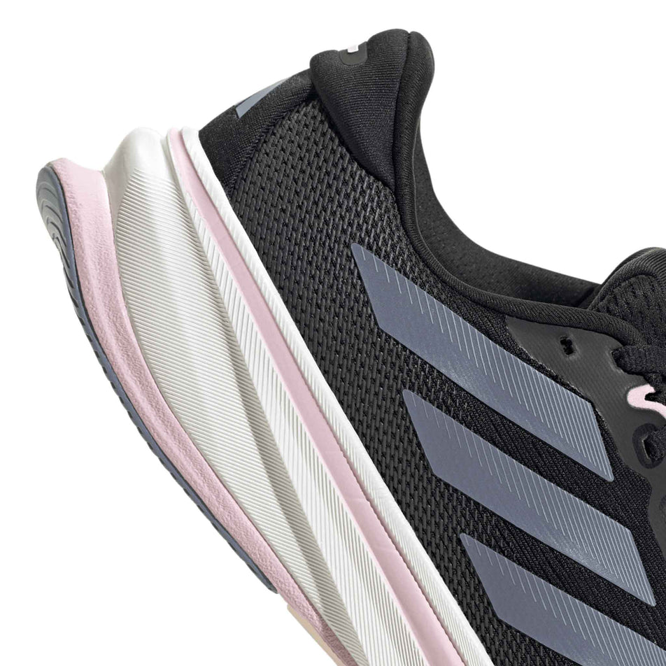 The heel section of the right shoe from a pair of adidas Women's Supernova Rise 2 Running Shoes Core Black/Silver Violet/Clear Pink colourway. (8662999695522)