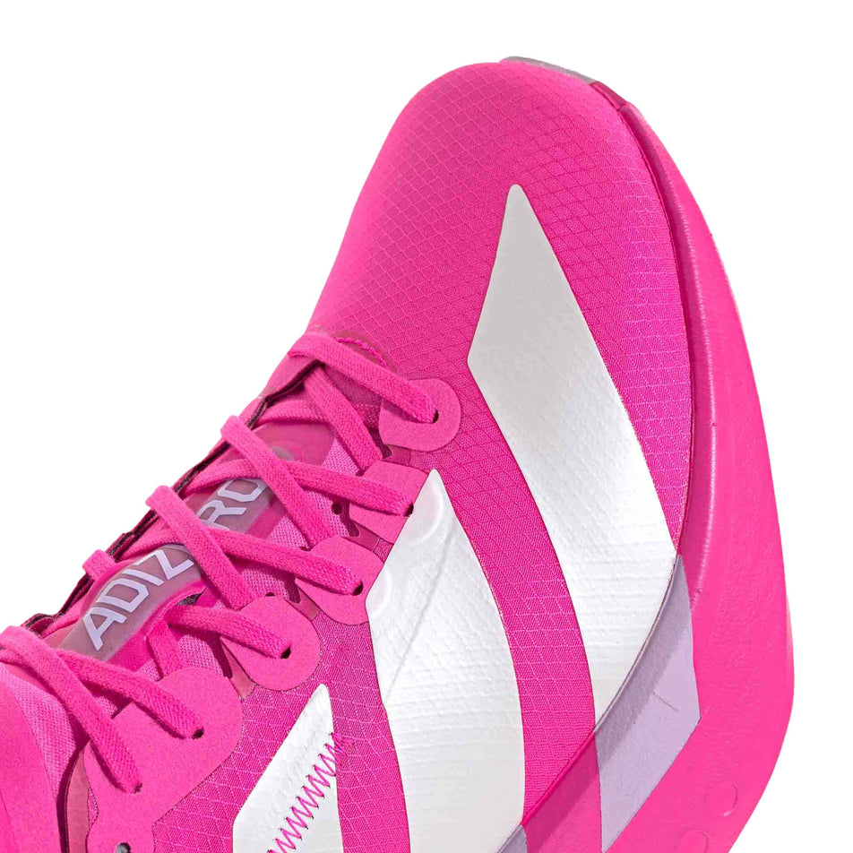 Close-up of the toe box of the right shoe from a pair of adidas Men's Adizero Adios Pro 4 Running Shoes in the Shock Pink/Zero Met./Aurora Plum colourway. (8743557595298)