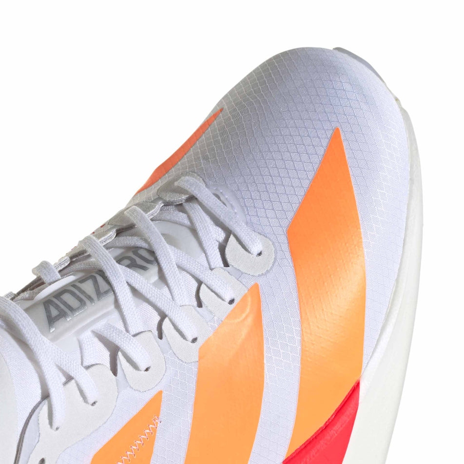 Close-up view of the toe box of the right shoe from a pair of adidas Men's Adizero Adios Pro 4 Running Shoes in the Ftwr White/Lucid Orange/Lucid Red colourway.