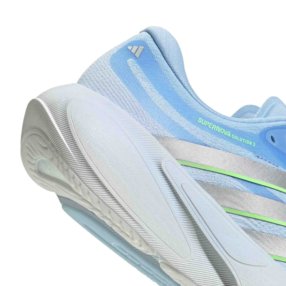 The rearfoot section of the right shoe from a pair of adidas Women's Supernova Solution 3 Running Shoes in the Crystal Sky/Silver met./Lime Burst colourway.