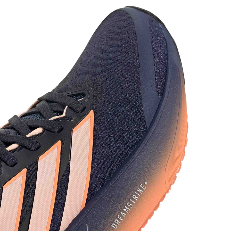 Close-up view of the toebox of the right shoe from a pair of adidas Women's Supernova Solution 3 Running Shoes in the Dark Blue/Clear Orange/Beam Orange colourway.