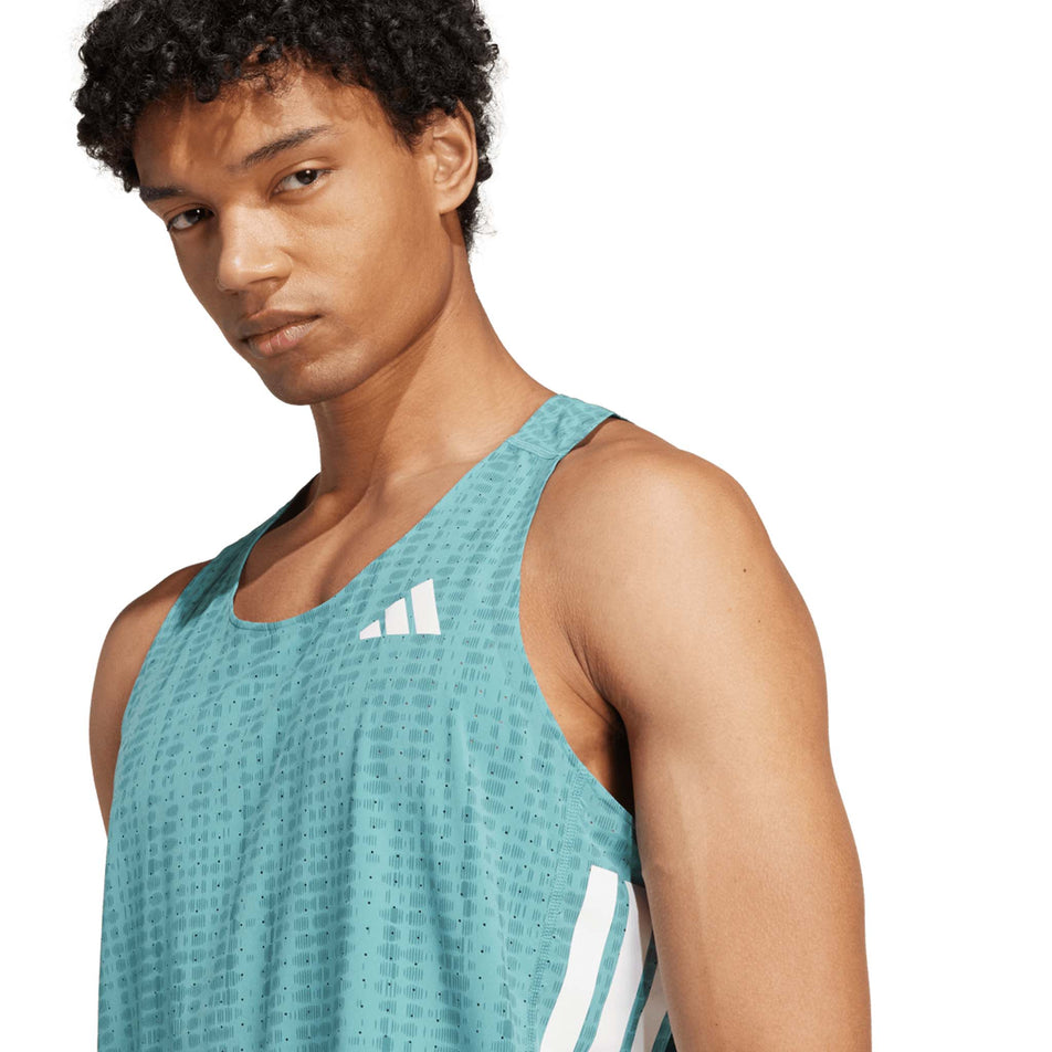 Front view of a model wearing the adidas Men's Adizero Singlet in the Powder Teal/Preloved Teal colourway. (8663045603490)
