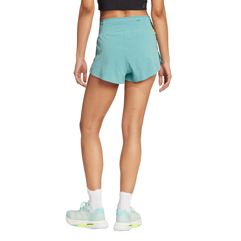 Back view of a model wearing the adidas Women's Adizero Gel Short in the Powder Teal colourway. (8664880611490)