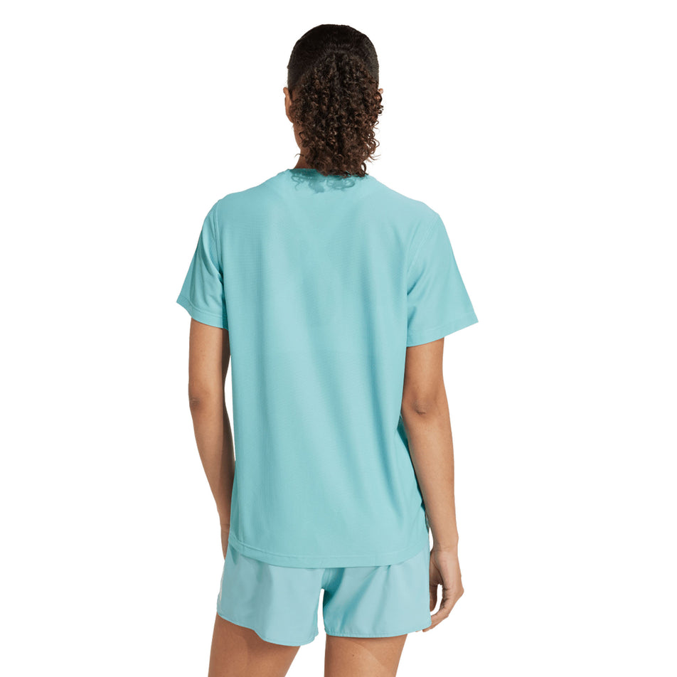 Back view of a model wearing the adidas Women's Own The Run Base Tee in the Mint Ton colourway. (8665229459618)