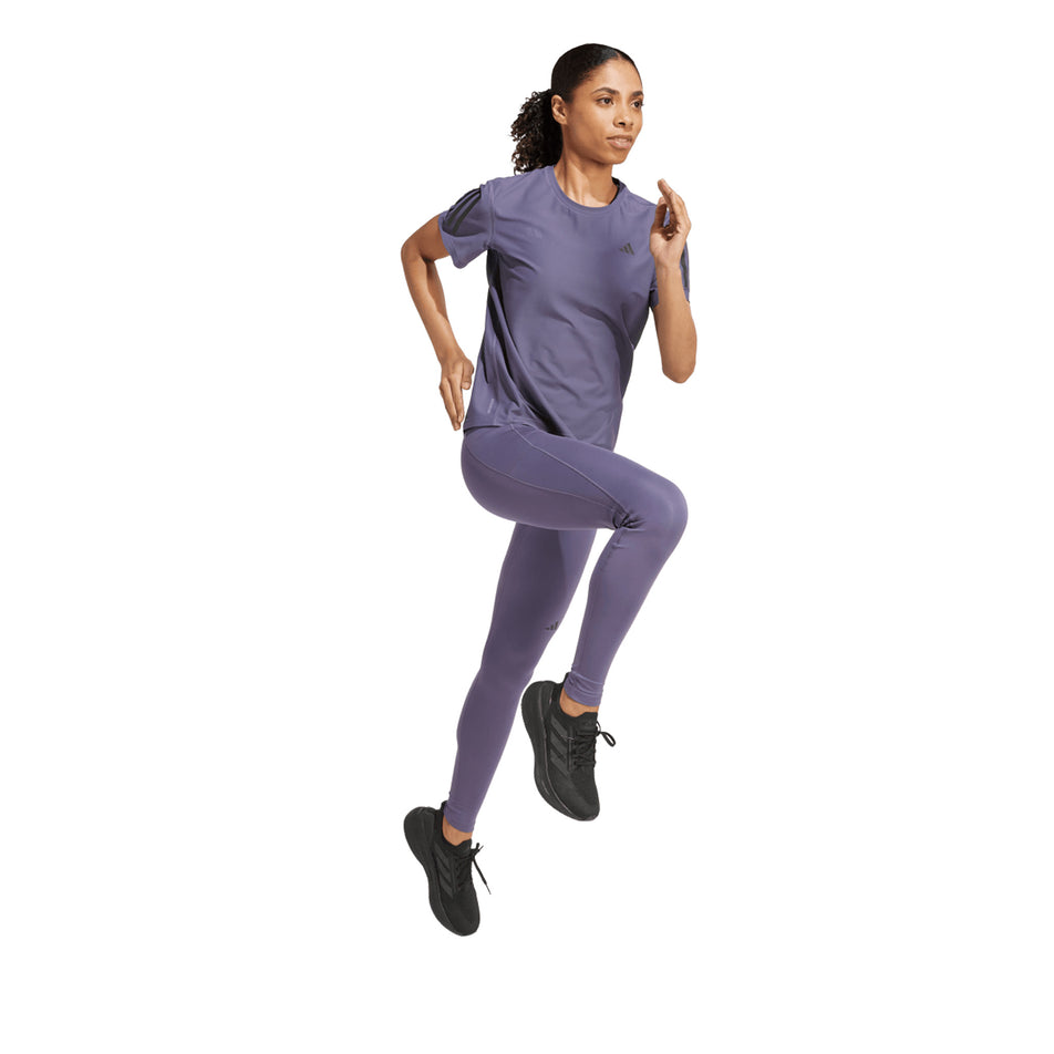 Front view of a model wearing the adidas Women's Own The Run Base Tee in the Preloved Violet colourway. (8665231327394)