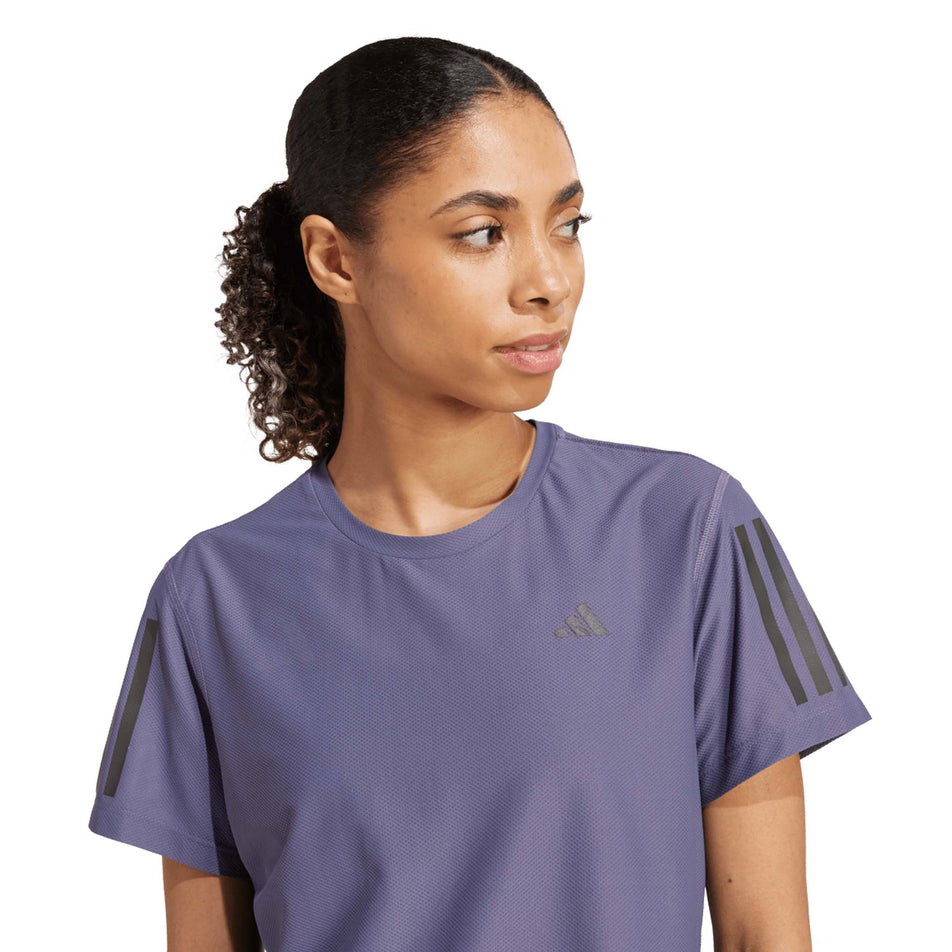 Front view of a model wearing the adidas Women's Own The Run Base Tee in the Preloved Violet colourway. (8665231327394)
