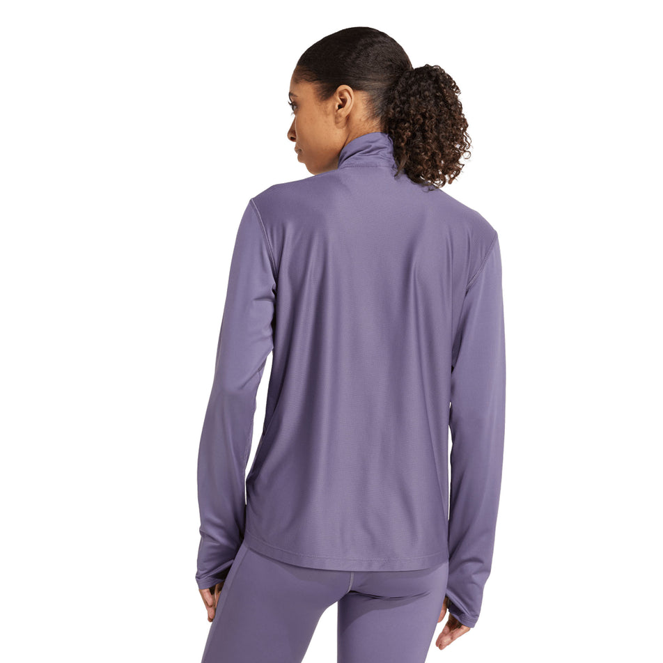 Back view of a model wearing the adidas Women's Own The Run Half Zip in the Preloved Violet colourway. (8751042527394)