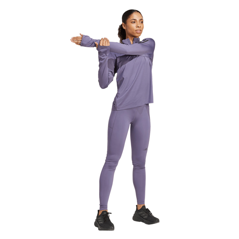 Front view of a model wearing the adidas Women's Own The Run Half Zip in the Preloved Violet colourway. (8751042527394)