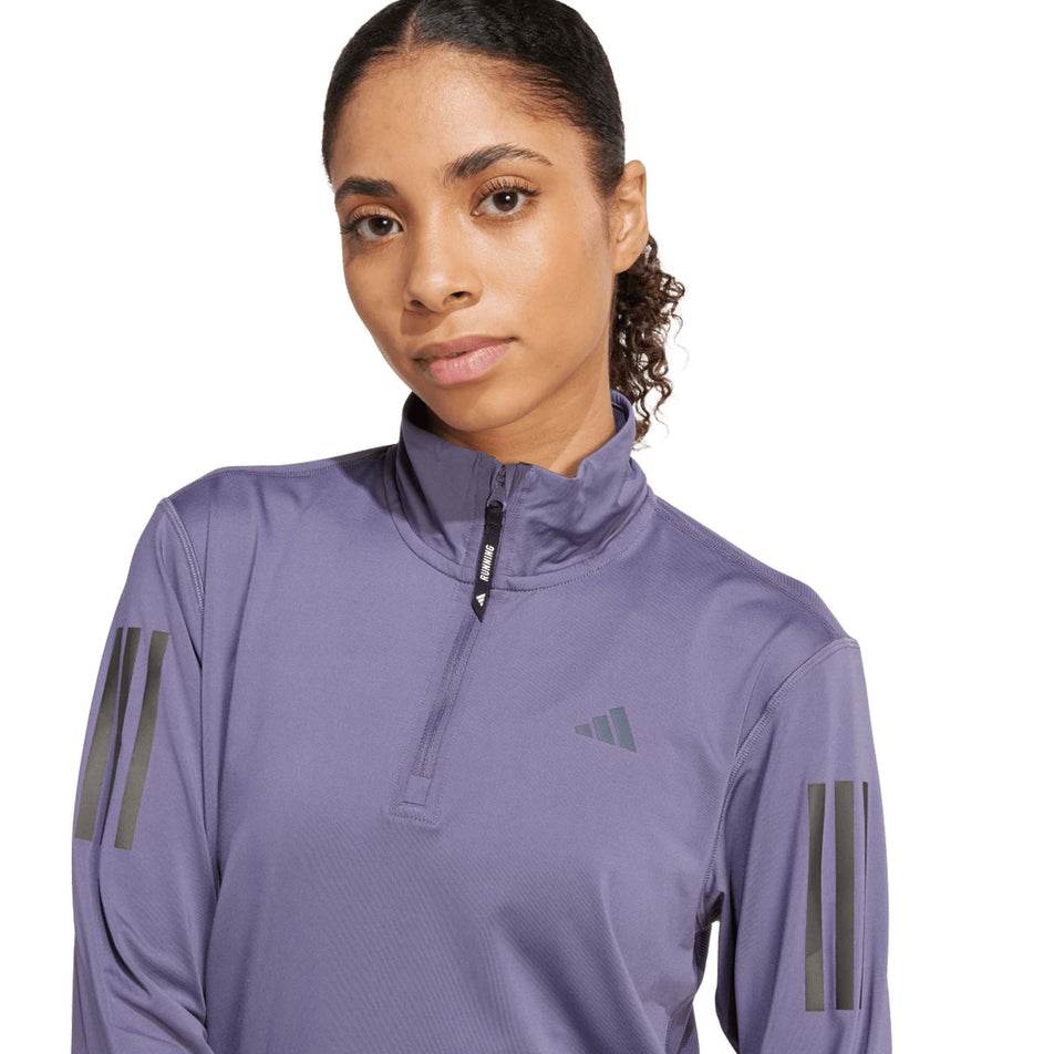 Front view of a model wearing the adidas Women's Own The Run Half Zip in the Preloved Violet colourway. (8751042527394)
