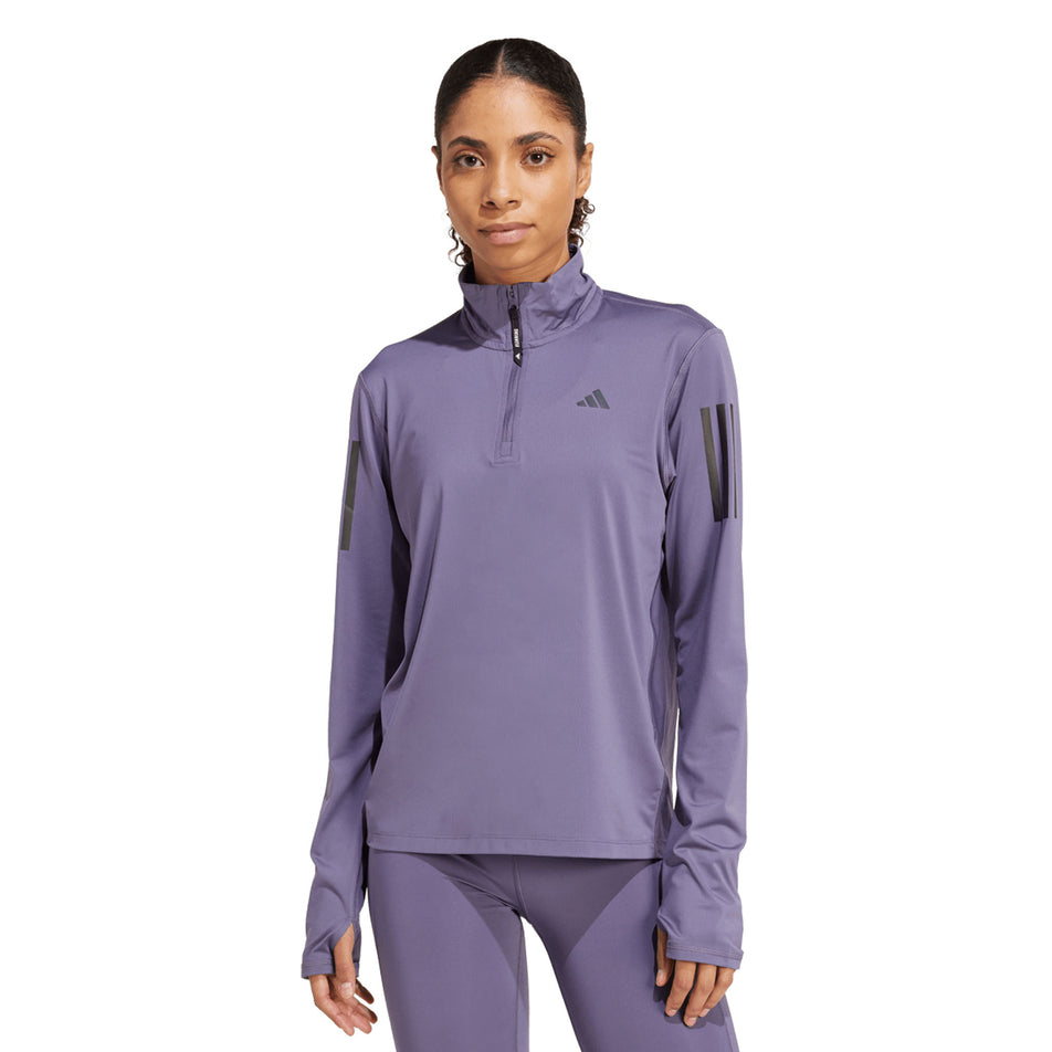 Front view of a model wearing the adidas Women's Own The Run Half Zip in the Preloved Violet colourway. (8751042527394)