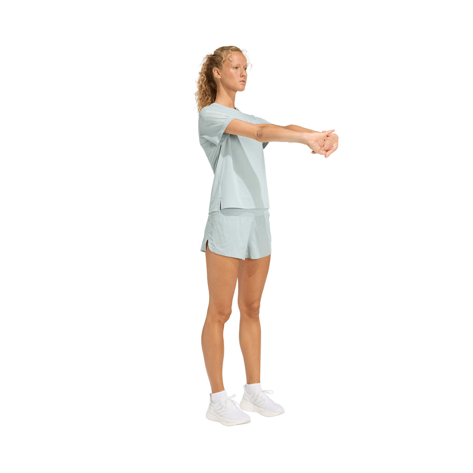 Angled view of a model wearing the adidas Women's adi365 Tee in the Wonder Sage colourway.
