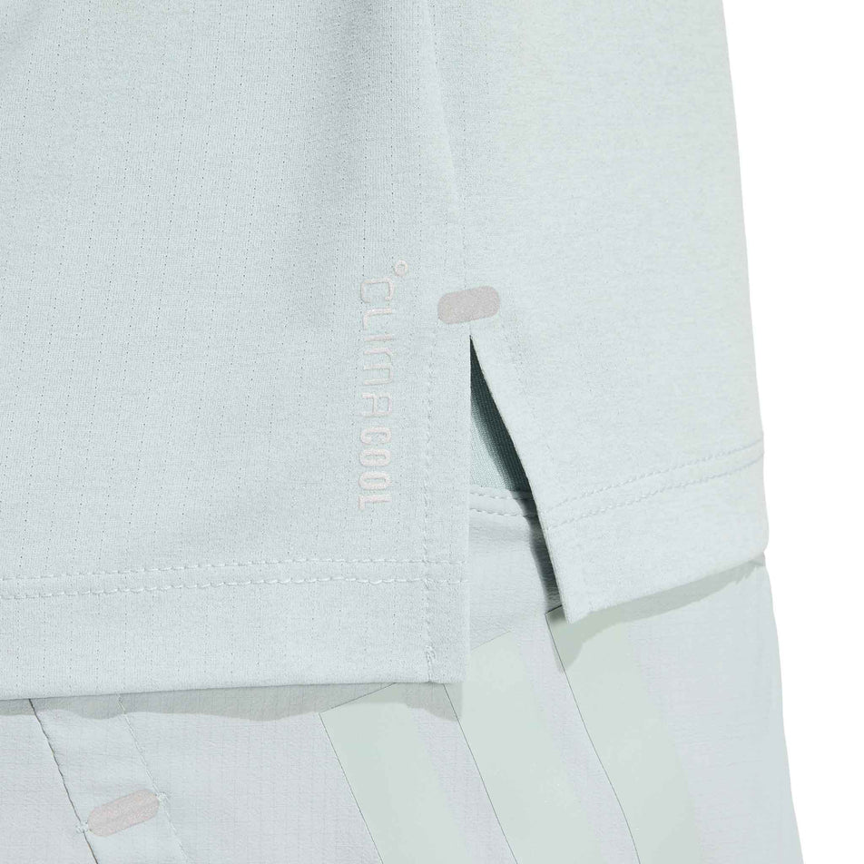 Close-up view of the side split at the hem of the adidas Women's adi365 Tee in the Wonder Sage colourway.