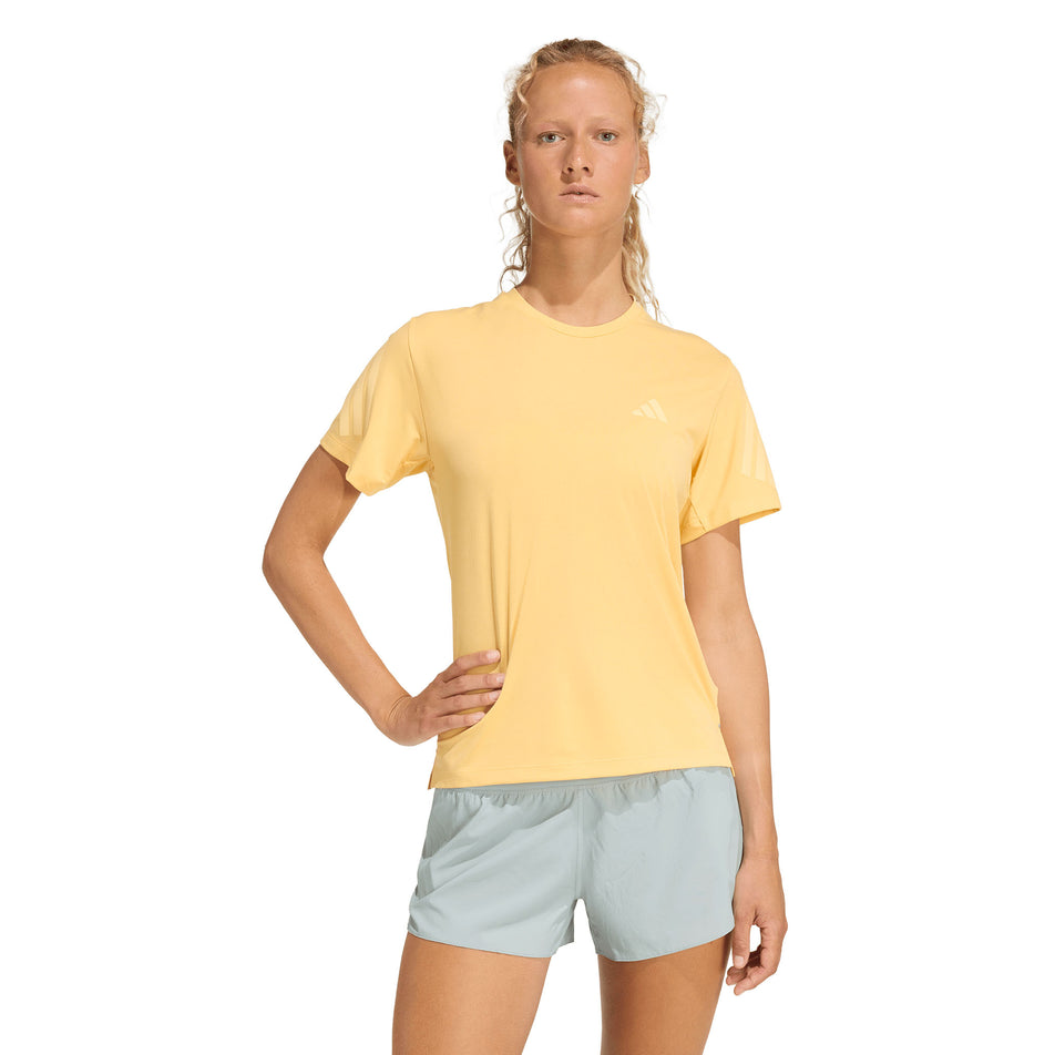 Front view of a model wearing the adidas Women's adi365 Tee in the Semi Ice Tangerine colourway.