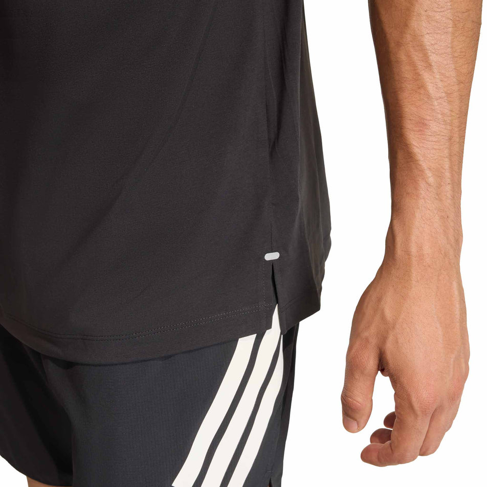 Close-up view of the side split on the hem of the adidas Men's adi365 Tee in the Black colourway.