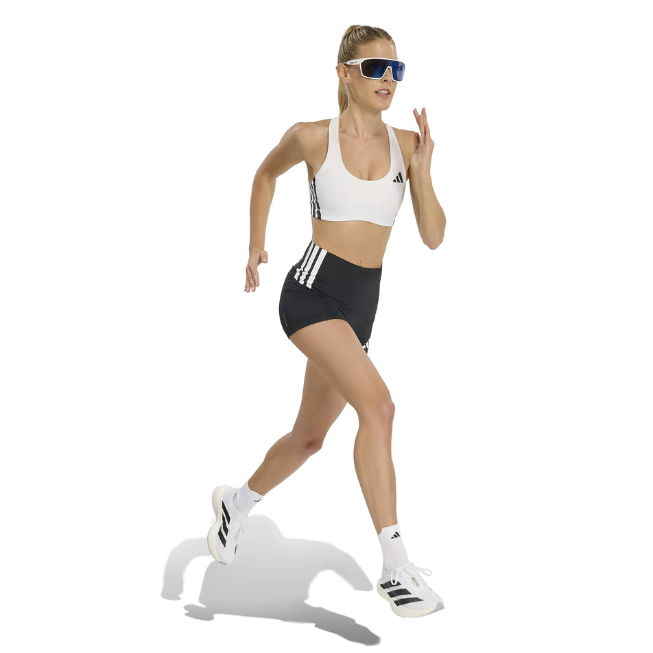 Angled view of a model wearing the adidas Women's Adizero Short Leggings in the Black colourway.