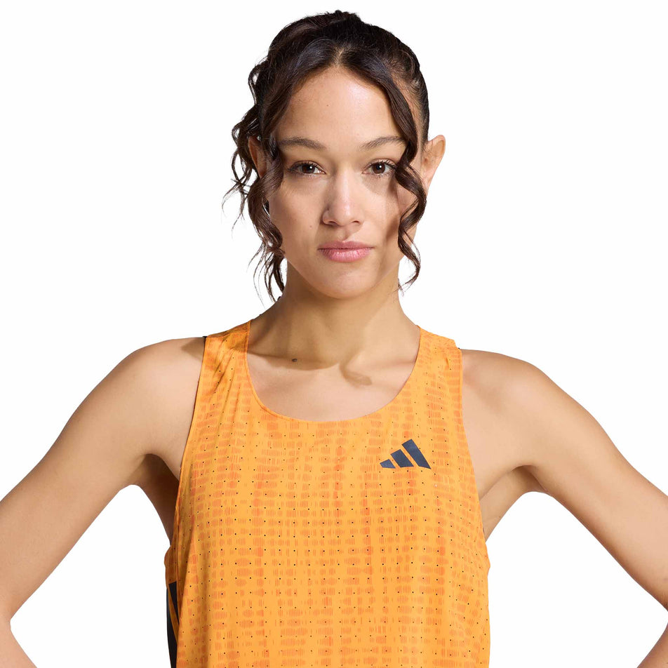Front view of a model wearing the adidas Women's Adizero Singlet in the Pure Tangerine/Pure Orange colourway.