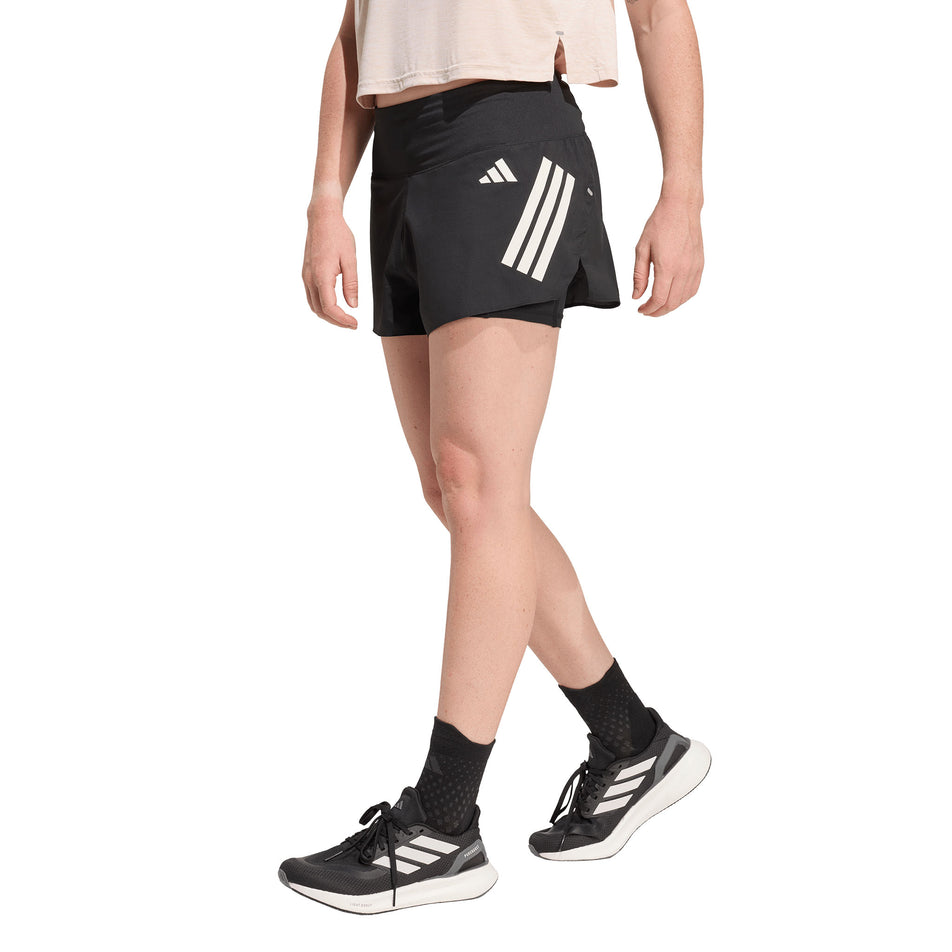 Angled view of a model wearing the adidas Women's adi365 2in1 Short in the Black colourway.